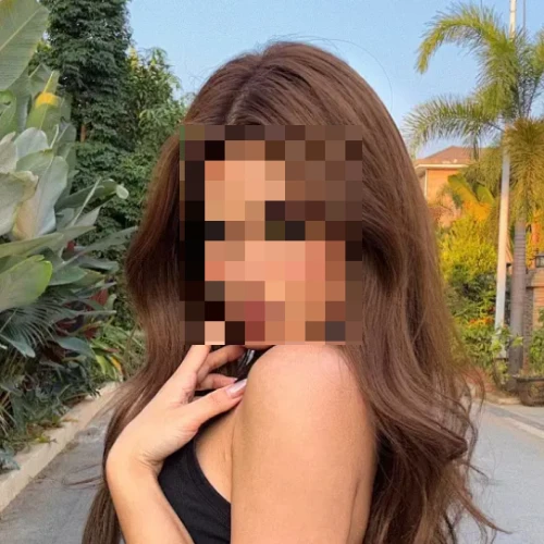 Woman outdoors with her face pixelated