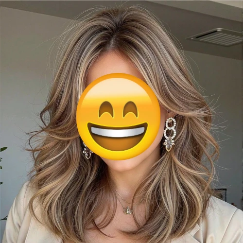 Woman with her face covered by a grinning emoji